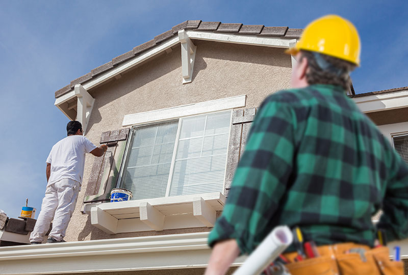 House painters Melbourne working on exterior residential painting with careful surface preparation.